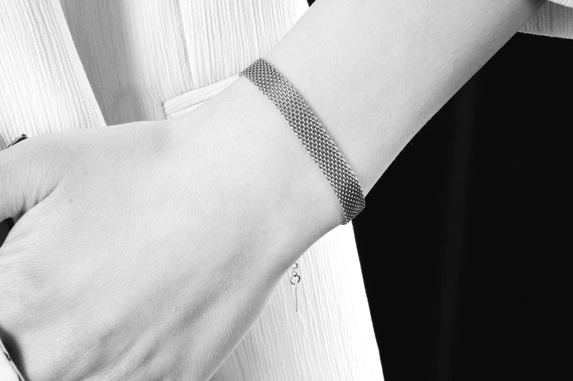 Hand showing embroidered cuff detail