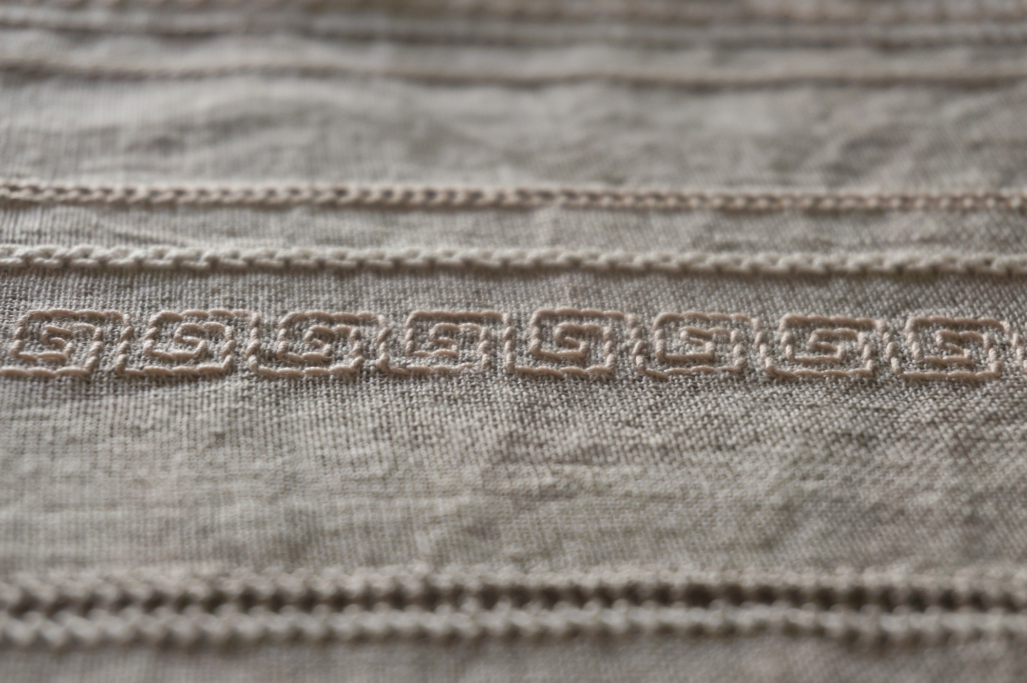 Close-up of handcrafted embroidery on linen